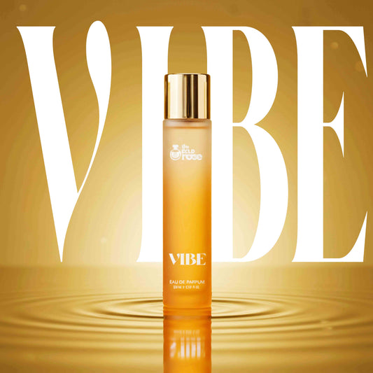 The Bold Rose VIBE perfume bottle in bright orange and gold, designed for girls in India, representing energy, confidence, and a mood-boosting fragrance.