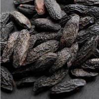 Close-up of dark raisins on a dark surface