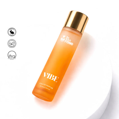 Orange perfume bottle with gold cap on a white background