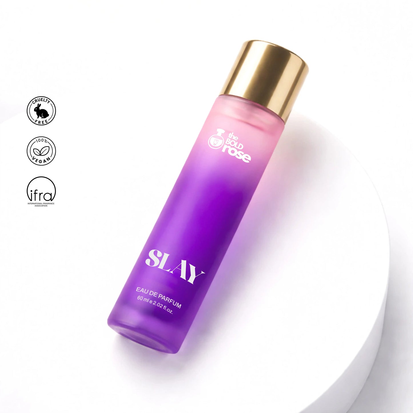 Purple perfume bottle with gold cap on a white background