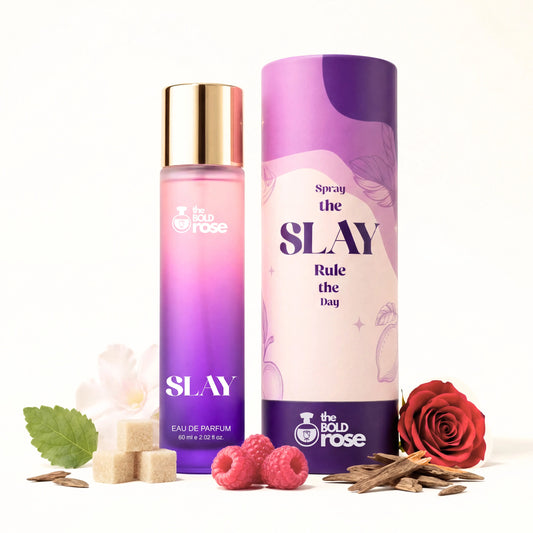 Two bottles of 'Slay' perfume by The Bold Rose on a white background with decorative elements. the-bold-rose-slay-purple-perfume